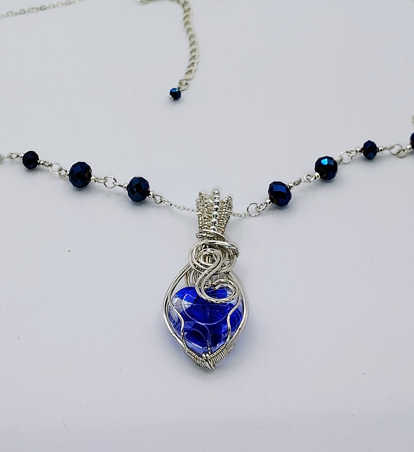 SILVER-PLATED AND BLUE HEART NECKLACE WITH ACCENT BEADS.